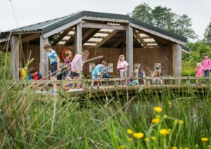 A group of children exploring part of Seaton Wetlands.